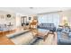 Inviting living room featuring hardwood floors, modern furniture, and ample natural light at 2897 Rosery Ne Rd, Largo, FL 33771