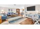 Bright and airy living room featuring hardwood floors, modern furniture, and an open layout at 2897 Rosery Ne Rd, Largo, FL 33771