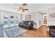 Cozy living room features hardwood floors, ceiling fan, and access to the pool at 2897 Rosery Ne Rd, Largo, FL 33771