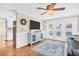 Open concept living room with a blue cabinet, ceiling fan, and pool view at 2897 Rosery Ne Rd, Largo, FL 33771