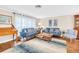 Comfortable living room with hardwood floors, stylish furniture, and bright, sheer curtains at 2897 Rosery Ne Rd, Largo, FL 33771