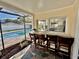 View of the outdoor patio bar featuring a convenient pass-through window to the interior kitchen and in-ground swimming pool at 2897 Rosery Ne Rd, Largo, FL 33771
