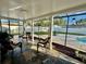 Screened-in patio with slate flooring and access to a pool, perfect for relaxing at 2897 Rosery Ne Rd, Largo, FL 33771