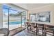 Outdoor patio bar with seating overlooking the sparkling swimming pool. Relax and enjoy! at 2897 Rosery Ne Rd, Largo, FL 33771