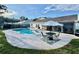 Relaxing pool area with lounge chairs and outdoor seating, perfect for entertaining at 2897 Rosery Ne Rd, Largo, FL 33771