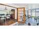View of dining room from sunroom with tile floors, screened windows and wicker seating at 2897 Rosery Ne Rd, Largo, FL 33771