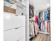 Walk-in closet featuring shelving, drawers, hanging rods, and wood-look flooring at 2897 Rosery Ne Rd, Largo, FL 33771