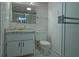 Cozy bathroom features a vanity with marble countertop, mirrored medicine cabinet, and a toilet at 290 13Th N Ave, Safety Harbor, FL 34695