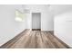 A bright bedroom with hardwood floors, window, closet, and entry door at 290 13Th N Ave, Safety Harbor, FL 34695