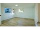 Bedroom featuring hardwood floors, a window, closet, and entry door at 290 13Th N Ave, Safety Harbor, FL 34695