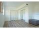 Bedroom featuring hardwood floors, a window, closet, and ottoman at 290 13Th N Ave, Safety Harbor, FL 34695