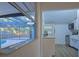 Bright kitchen with stainless steel appliances, white cabinets, and a view of the backyard pool at 290 13Th N Ave, Safety Harbor, FL 34695