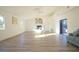 Spacious living room with hardwood floors, high ceilings, fireplace, and access to a patio at 290 13Th N Ave, Safety Harbor, FL 34695