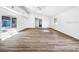Spacious living room with wood floors, sliding glass doors to the pool and bright, airy atmosphere at 290 13Th N Ave, Safety Harbor, FL 34695