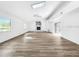 Bright, expansive living room with wood floors, fireplace, and skylights at 290 13Th N Ave, Safety Harbor, FL 34695