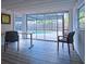 Bright living room features sleek wood floors and access to an outdoor pool area at 290 13Th N Ave, Safety Harbor, FL 34695