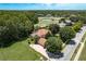 Aerial view featuring the home with mature trees, manicured lawn, and access to the community golf course at 3042 Wentworth Way, Tarpon Springs, FL 34688