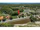 Aerial view showcasing a beautiful home nestled within a lush, green landscape with ponds nearby at 3042 Wentworth Way, Tarpon Springs, FL 34688