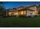 An expansive backyard featuring a screened lanai and lush landscaping, perfect for outdoor enjoyment at 3042 Wentworth Way, Tarpon Springs, FL 34688