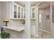 A well-appointed bar area with glass-front cabinets, marble countertops, and stylish décor at 3042 Wentworth Way, Tarpon Springs, FL 34688