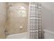 Bright bathroom features a tub/shower combo with modern fixtures and a neutral color palette at 3042 Wentworth Way, Tarpon Springs, FL 34688