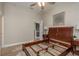 Bedroom with wood flooring, ceiling fan, and doorway to the wet bar at 3042 Wentworth Way, Tarpon Springs, FL 34688