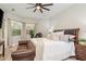Cozy bedroom with a large bed, leather sofa, and bright windows, offering a relaxing retreat at 3042 Wentworth Way, Tarpon Springs, FL 34688