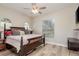 Comfortable bedroom with a decorative ceiling fan, a window and wood-look floors at 3042 Wentworth Way, Tarpon Springs, FL 34688