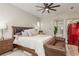 Spacious bedroom features a king bed, leather sofa, and stylish furniture, creating a luxurious atmosphere at 3042 Wentworth Way, Tarpon Springs, FL 34688