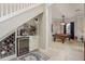 Wine storage with coffee bar under the staircase, leading to a billiards room at 3042 Wentworth Way, Tarpon Springs, FL 34688