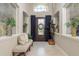 Grand foyer with decorative glass, a unique suit of armor, and a tiled floor at 3042 Wentworth Way, Tarpon Springs, FL 34688
