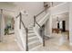 Grand foyer with staircase, neutral tones, and open view to the game room, creating an inviting entrance at 3042 Wentworth Way, Tarpon Springs, FL 34688