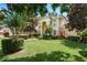 Beautifully landscaped home with mature trees and a lush, green lawn at 3042 Wentworth Way, Tarpon Springs, FL 34688