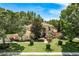 Beautiful home with a well manicured lawn, mature trees, and charming landscaping at 3042 Wentworth Way, Tarpon Springs, FL 34688