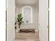 Inviting hallway with a decorative bench, stone accent wall, and arched doorways, creating an elegant entrance at 3042 Wentworth Way, Tarpon Springs, FL 34688