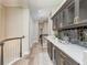 Hallway features elegant built-in cabinets with glass doors and a mirrored backsplash, adding sophistication at 3042 Wentworth Way, Tarpon Springs, FL 34688