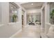 Open hallway leading to a sun-filled living room at 3042 Wentworth Way, Tarpon Springs, FL 34688