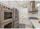 Kitchen featuring stainless steel appliances, white cabinets, and marble countertops at 3042 Wentworth Way, Tarpon Springs, FL 34688