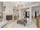 Spacious living room featuring fireplace, elegant decor, and natural light at 3042 Wentworth Way, Tarpon Springs, FL 34688