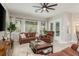 Inviting living room with leather furniture, large windows, and views to pool at 3042 Wentworth Way, Tarpon Springs, FL 34688