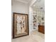 The office features sophisticated decor and an open doorway to built-in shelving for stylish storage at 3042 Wentworth Way, Tarpon Springs, FL 34688