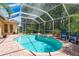 Relax in this large swimming pool and spa with a screened enclosure for year-round enjoyment at 3042 Wentworth Way, Tarpon Springs, FL 34688