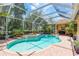 The screened-in pool area features a swimming pool, spa, and patio space at 3042 Wentworth Way, Tarpon Springs, FL 34688