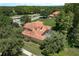 Aerial view of the backyard, pool, and home showing mature trees surrounding the property at 3042 Wentworth Way, Tarpon Springs, FL 34688