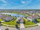 Stunning aerial view of a home with pond and meticulously maintained lawns at 30732 Summer Sun Loop, Wesley Chapel, FL 33545