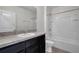 Bright bathroom with a shower-tub combination and vanity with dark wood cabinets at 30732 Summer Sun Loop, Wesley Chapel, FL 33545