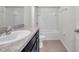 Bright bathroom with a shower-tub combination and vanity with dark wood cabinets at 30732 Summer Sun Loop, Wesley Chapel, FL 33545