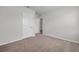 Empty bedroom featuring neutral carpet, baseboards, and two doors at 30732 Summer Sun Loop, Wesley Chapel, FL 33545