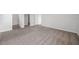 Light and neutral bedroom with carpeted floor and adjacent entry ways to closets and bathroom at 30732 Summer Sun Loop, Wesley Chapel, FL 33545