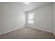 Neutral carpeted bedroom with a window for natural light at 30732 Summer Sun Loop, Wesley Chapel, FL 33545